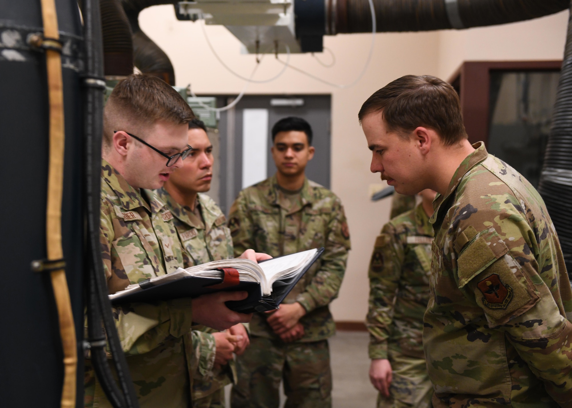 Tech. Sgt. Thomas Bozeman, the facilities maintenance section training non-commissioned officer in charge at the 373rd Training Squadron, Detachment 321, instructs a group of Airmen at F.E. Warren Air Force Base, Wyoming, May 10, 2022. Bozeman helps Airmen gain additional skills needed to complete the mission at the missile complex. (U.S. Air Force photo by Airman 1st Class Darius Frazier.)