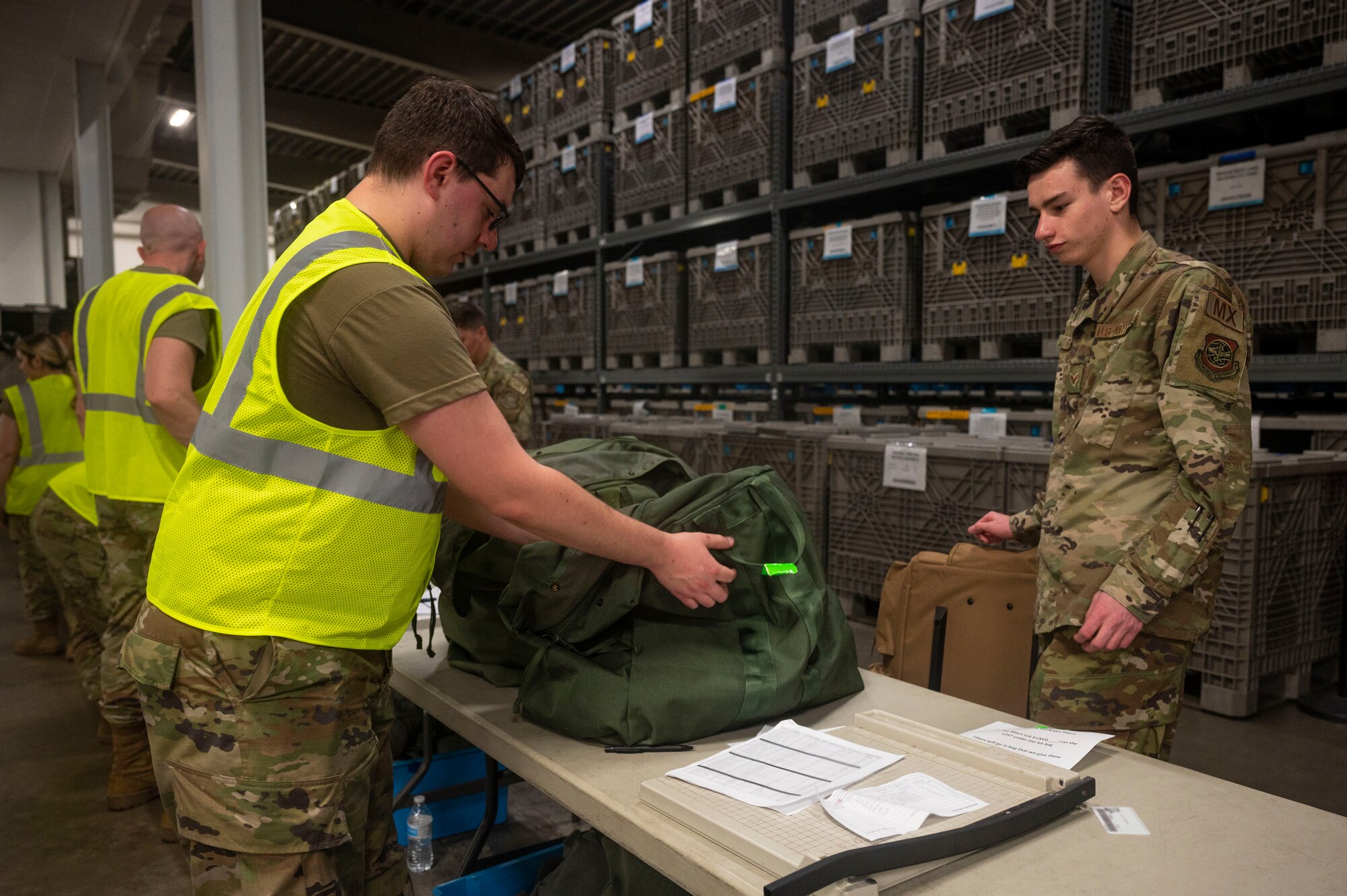 An Airman assigned to the 19th Airlift Wing checks out a deployment bag containing Mission Oriented Protective Posture gear during Phase 1 of ROCKI 22-03