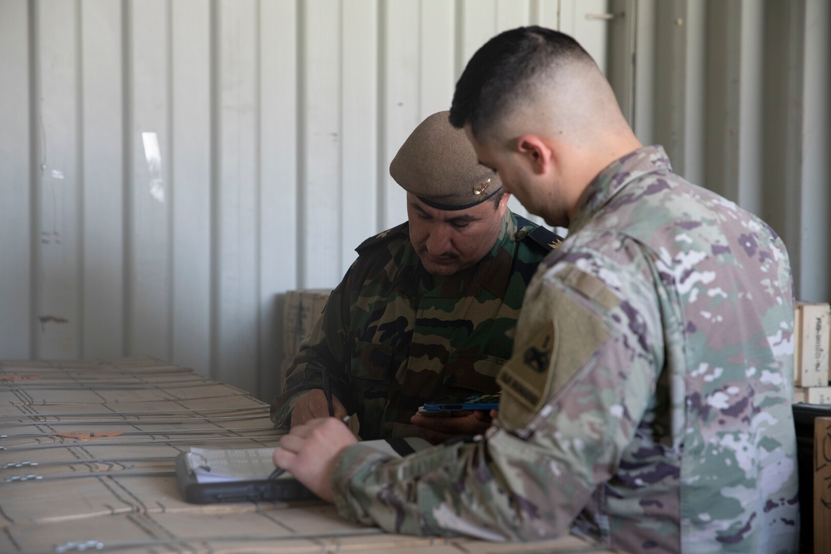 Maj. Arkan Awla Perot, M4 warehouse liaison, and U.S. Army 1st Lt. Raphael Valles, reporting officer with the Counter-ISIS Train and Equip Fund (CTEF) program, verifies the amount of ammunition being divested at Erbil Air Base, Iraq, March 8, 2022. The Combined Joint Task Force - Operation Inherent Resolve’s CTEF program has divested more than $500 million of equipment, vehicles, weapons and ammunition in an effort to advise, assist, and enable partner forces in the enduring defeat of Daesh. (U.S. Army photo by Cpl. Tommy L. Spitzer)