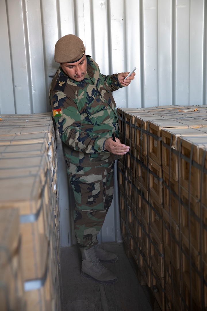 Maj. Arkan Awla Perot, M4 warehouse liaison, verifies the amount of ammunition being divested at Erbil Air Base, Iraq, March 8, 2022. The Combined Joint Task Force - Operation Inherent Resolve’s CTEF program has divested more than $500 million of equipment, vehicles, weapons and ammunition in an effort to advise, assist, and enable partner forces in the enduring defeat of Daesh. (U.S. Army photo by Cpl. Tommy L. Spitzer)