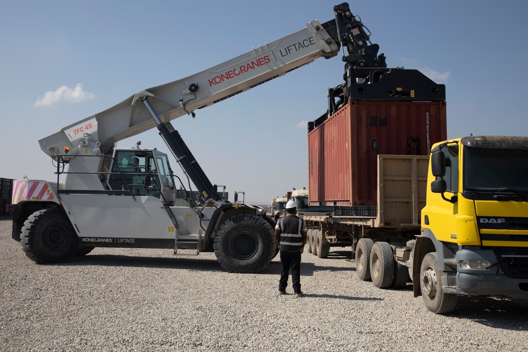Contractors load a container of ammunition onto a trailer following a Counter - ISIS Train and Equip Fund (CTEF) program divestment to the Ministry of Peshmerga at Erbil Air Base, Iraq, March 8, 2022. The Combined Joint Task Force - Operation Inherent Resolve’s CTEF program has divested more than $500 million of equipment, vehicles, weapons and ammunition in an effort to advise, assist, and enable partner forces in the enduring defeat of Daesh. (U.S. Army photo by Cpl. Tommy L. Spitzer)