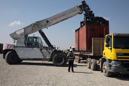 Contractors load a container of ammunition onto a trailer following a Counter - ISIS Train and Equip Fund (CTEF) program divestment to the Ministry of Peshmerga at Erbil Air Base, Iraq, March 8, 2022. The Combined Joint Task Force - Operation Inherent Resolve’s CTEF program has divested more than $500 million of equipment, vehicles, weapons and ammunition in an effort to advise, assist, and enable partner forces in the enduring defeat of Daesh. (U.S. Army photo by Cpl. Tommy L. Spitzer)