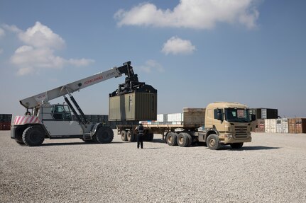 Contractors load a container of ammunition onto a trailer following a Counter - ISIS Train and Equip Fund (CTEF) program divestment to the Ministry of Peshmerga at Erbil Air Base, Iraq, March 8, 2022. The Combined Joint Task Force - Operation Inherent Resolve’s CTEF program has divested more than $500 million of equipment, vehicles, weapons and ammunition in an effort to advise, assist, and enable partner forces in the enduring defeat of Daesh. (U.S. Army photo by Cpl. Tommy L. Spitzer)