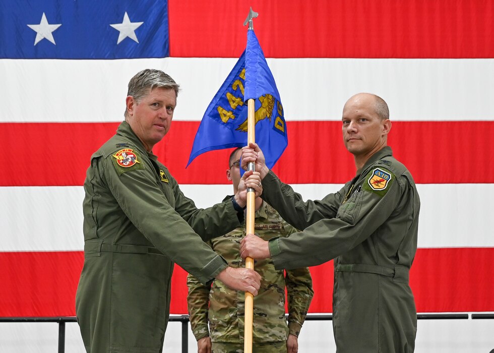 Col. Steve Nester, the 442d Fighter Wing commander, passes a guidon to Col. Mark Orek, the 442d Operations Group commander
