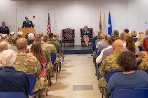 U.S. Air Force Col. Sandra L. Wilson, right, Vice Commander of the 162nd Wing, listens to Brig. Gen. Jeffrey Butler’s remarks during her retirement ceremony at Morris Air National Guard Base, May 14, 2022. (Air National Guard photo by Senior Master Sgt. Charles Givens)