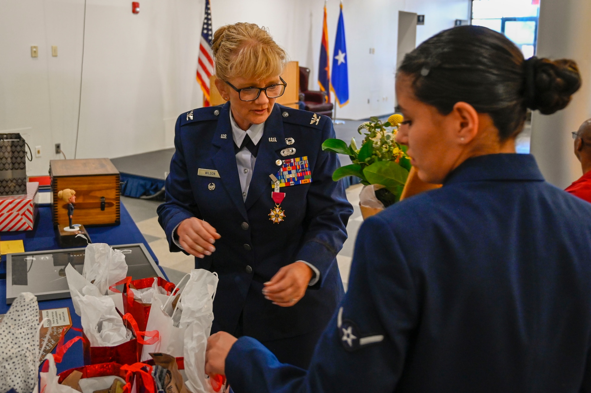 U.S Air Force Col. Sandra L. Wilson, Vice Commander of the 162nd Wing, prepares to hand out gifts during her retirement ceremony at Morris Air National Guard Base, May 14, 2022. (Air National Guard photo by Senior Master Sgt. Charles Givens)