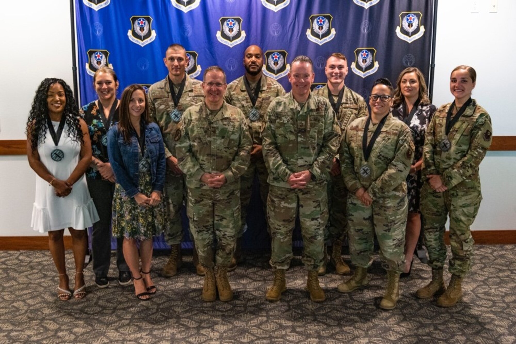 Air Force Special Operations Command’s 2021 Outstanding Airman of the Year pose for a photo with U.S. Air Force Lt. Gen. Jim Slife, commander of AFSOC, and Chief Master Sgt. Cory Olson, command chief of AFSOC, at the conclusion of the OAY Medallion breakfast at Hurlburt Field, Florida, May 11, 2022. In addition to the medallion breakfast, AFSOC formally recognized this year’s Outstanding Airmen of the Year award winners with a day of professional development events and a banquet (U.S. Air Force photo by Staff Sgt. Miranda Mahoney)