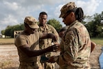 Alabama Army National Guard Sgts. Tymicheal Avery and Portia Staton test purified water during Operation Tradewinds 2022 at Price Barracks, Belize, May 13, 2022. Avery, Statonand the 1208th Quartermaster Company are supplying potable water for cooking, personal hygiene, and drinking to partner nations.