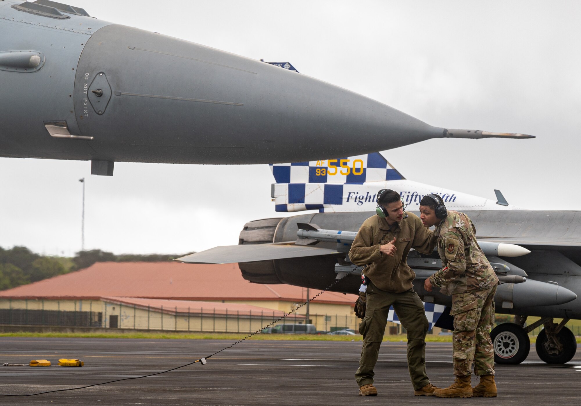 An Airman trains another Airman on F-16 aircraft maintenance.