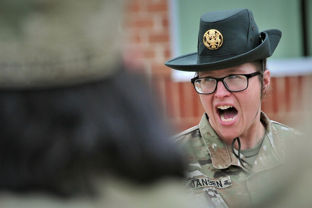 A soldier calls troops to attention.