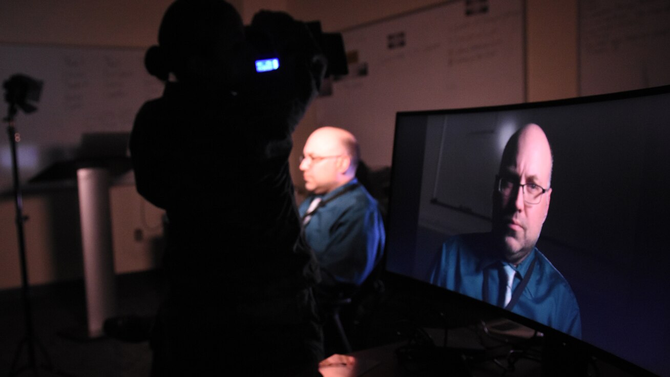 DINFOS students in Intermediate Motion Media Course conduct lighting training with portraits.
