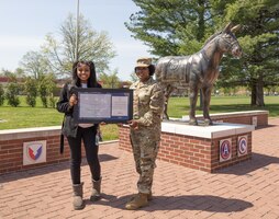 daughter shows award with Soldier mother