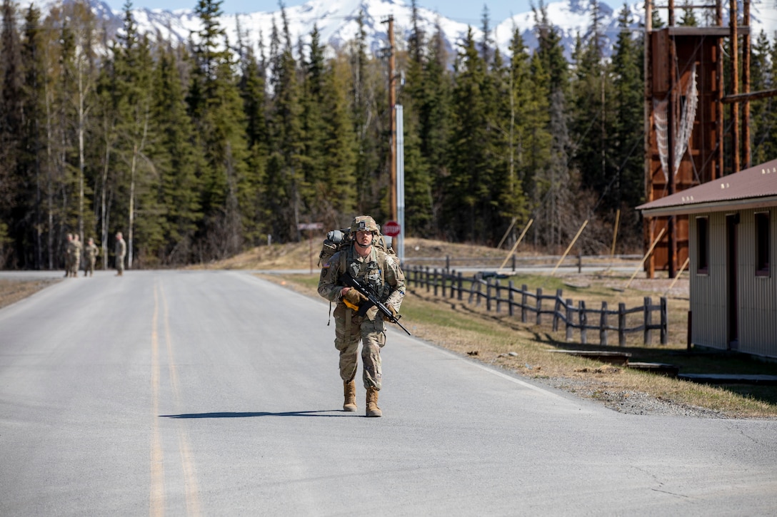 Alaska Army National Guard Spc. Mark Adair, with 207th Engineer Utilities Detachment, 297th Regional Support Group, participates in the 7.5-mile road march portion of the AKARNG’s Best Warrior Competition held at Joint Base Elmendorf-Richardson, Alaska, May 11, 2022. The six-day competition tests Soldiers’ mental and physical agility and toughness through a series of events that measure technical and tactical proficiency. (Alaska National Guard photo by 1st Lt. Balinda O’Neal)