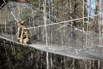 A Soldier crosses a Slide-for-Life obstacle during the Best Warrior Competition on Joint Base Elmendorf-Richardson, May 11, 2022. The six-day competition tests Soldiers’ mental and physical agility and toughness through a series of battle-focused events that measure technical and tactical proficiency. (U.S. Army National Guard photo by Victoria Granado)