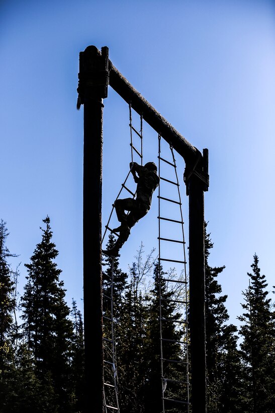 Sgt. Jeseb Mogen, a military police Soldier with Company A, 49th Missile Defense Battalion, climbs a rope ladder during the obstacle course part of the Best Warrior Competition held at Joint Base Elmendorf-Richardson, Alaska May 11. The six-day competition tests Soldiers’ mental and physical agility and toughness through a series of events that measure technical and tactical proficiency. (Alaska National Guard Photo by Staff Sgt. Katie Mazos-Vega)
