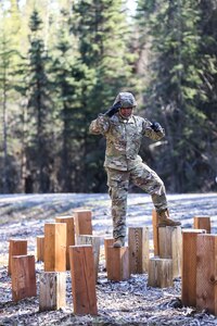 Spc. Eric Alvira-Ramos, a wheeled vehicle mechanic with Headquarters and Headquarters Battery, 49th Missile Defense Battalion, carefully navigates a balance obstacle during the Best Warrior Competition held at Joint Base Elemndorf-Richardson, Alaska May 11. The six-day competition tests Soldiers’ mental and physical agility and toughness through a series of events that measure technical and tactical proficiency. (Alaska National Guard photo by Staff Sgt. Katie Mazos-Vega)