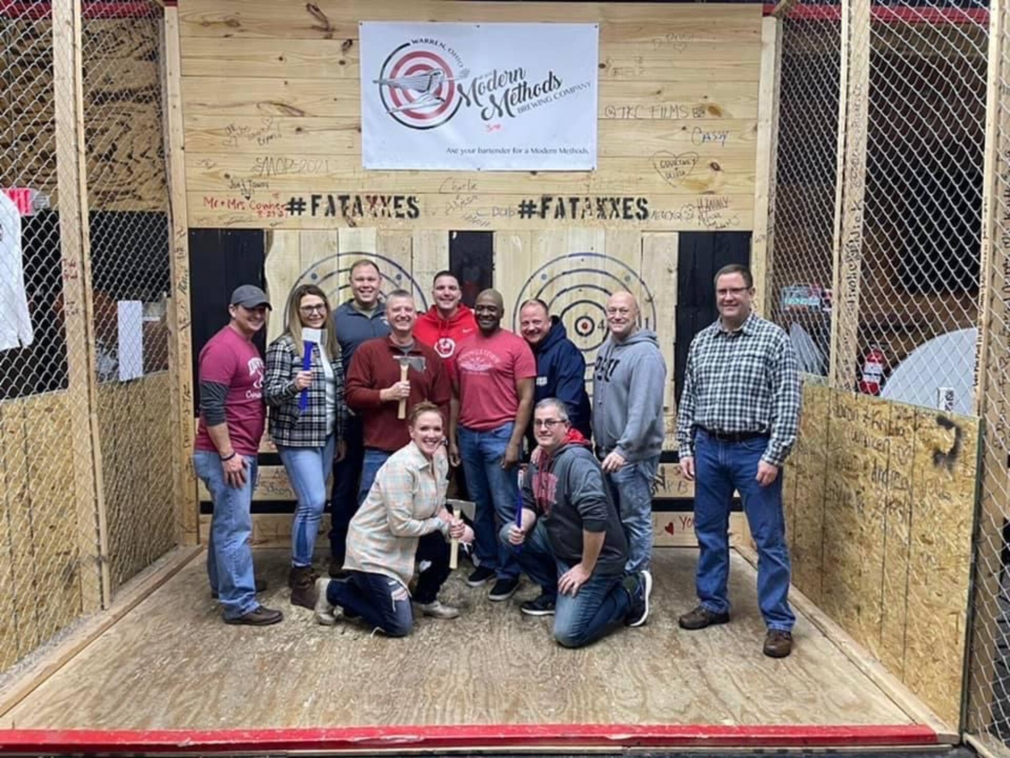 Chief Master Sgt. Jennifer McKendree, the 910th Airlift Wing command chief, poses at an axe-throwing morale event with fellow chiefs of the 910th Airlift Wing in Niles, Ohio, Feb 5, 2022.
