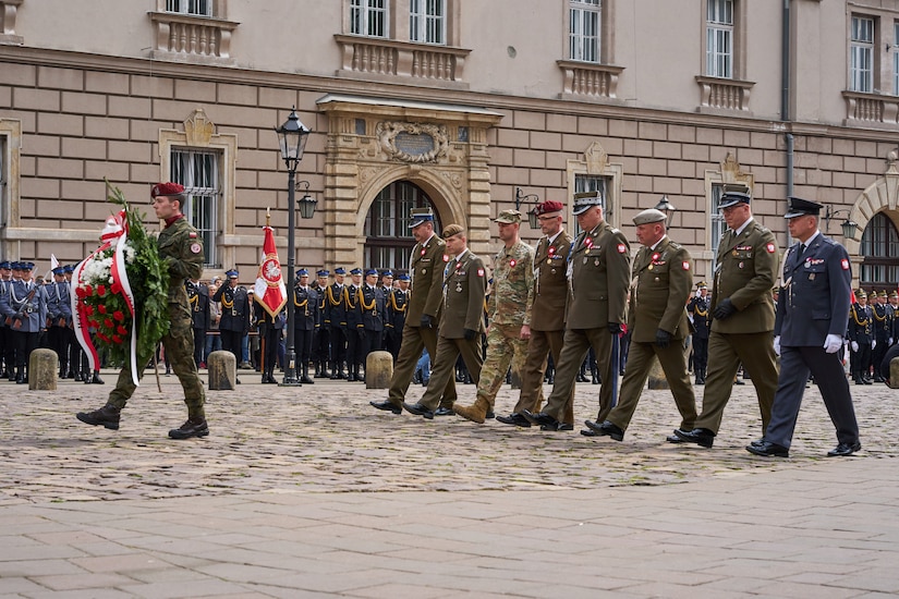 KRAKOW, Poland - Col. John Sandor, acting chief of staff, Defender-Europe 22 combined higher command, V Corps, and members of the Polish military take part in a wreath laying ceremony at the Cross of Katyn in Krakow, Poland, May 3, 2022. The wreath laying is part of the annual Constitution Day celebrations in Krakow. Constitution Day, a Polish holiday, is a celebration of the declaration of the Polish constitution on May 3, 1791. (U.S. Army photo by Sgt. Sean Hall)