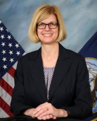 photo of Cindy Reader posing in front of United States flag