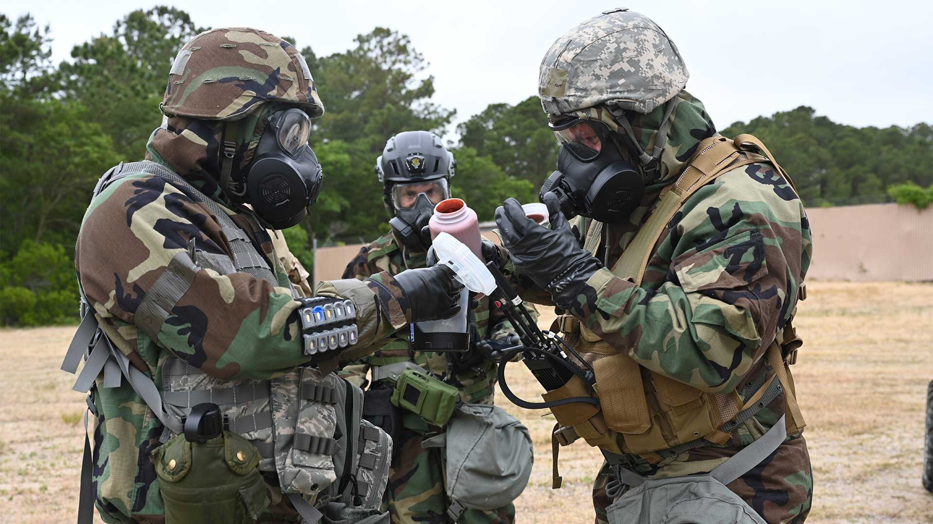 Joint Forces team members prepare the "Sprayable Slurry" demonstration at a decontamination station. The photo, taken at the 2021 CBOA,  showcases the many technological advances, prototypes, and DTRA's capabilities.