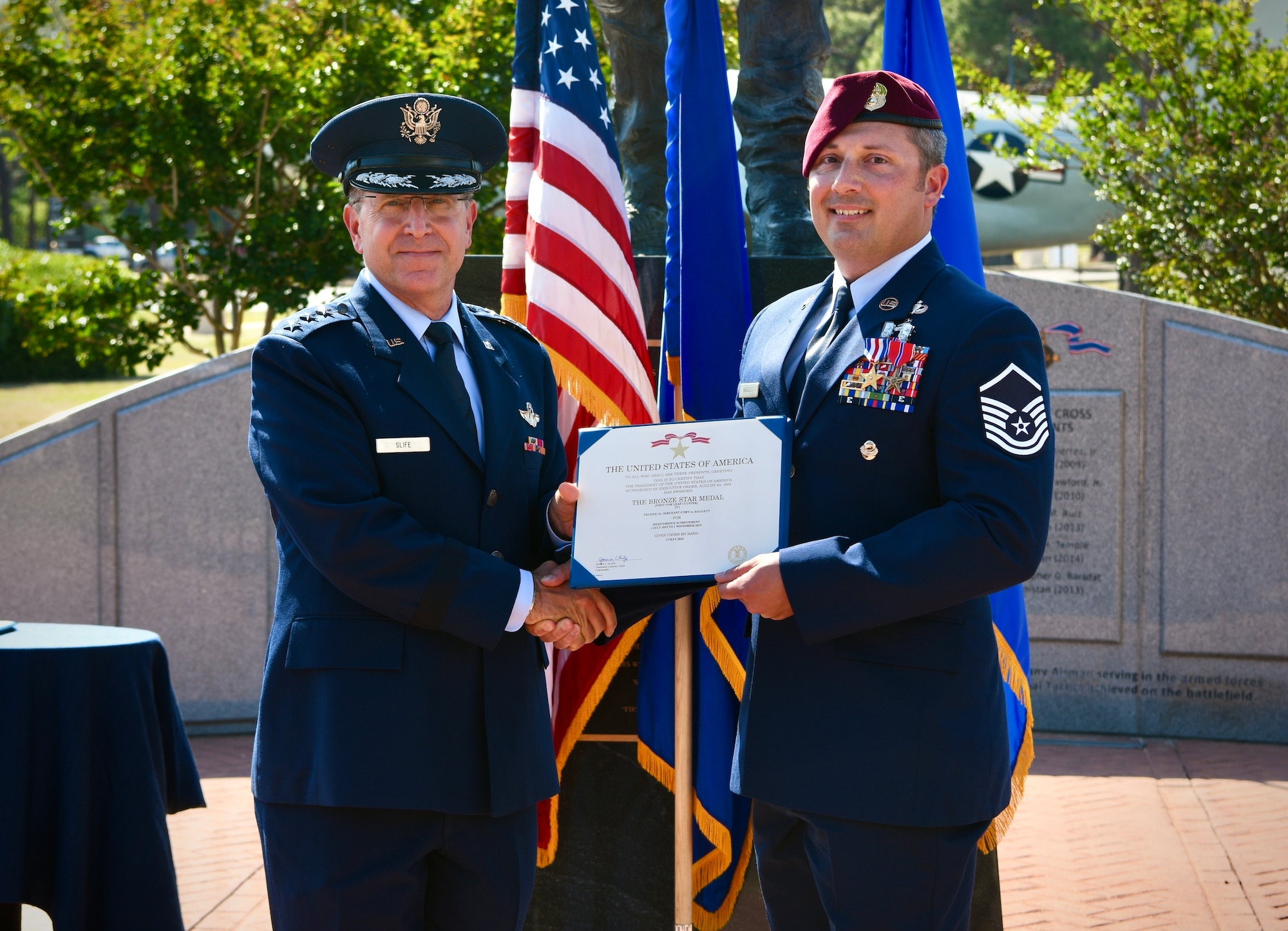 U.S. Air Force Lt. Gen. Jim Slife, commander of Air Force Special Operations Command, presents the Bronze Star Medal to Master Sgt. Cory Haggett, a special tactics operator with the 23d Special Tactics Squadron, 24th Special Operations Wing, during a ceremony May 13, 2022, at Hurlburt Field, Fla.  Haggett was also presented the Silver Star during the ceremony.