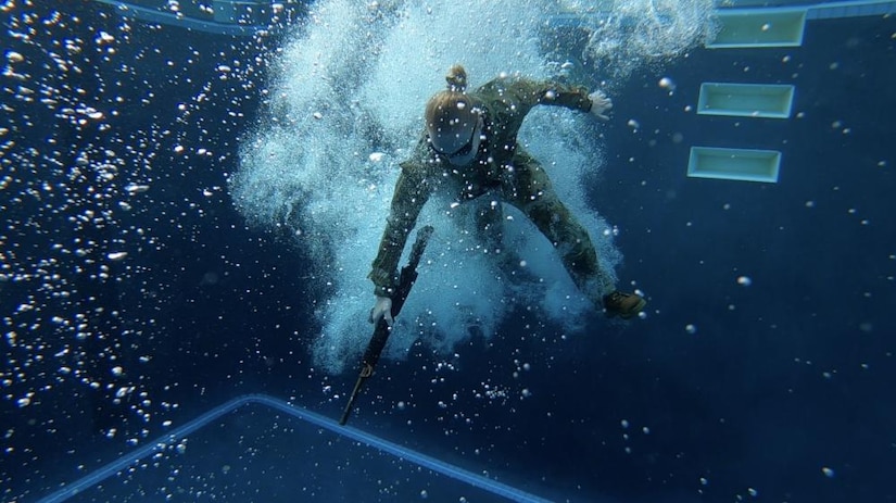 A Soldier completes one of three required water survival lane obstacles during the Regional Health Command-Pacific Best Leader Competition at the Tripler Army Medical Center Pool, May 9 2022. (Video screenshot courtesy of Sgt. Yamil JorgeTorres)