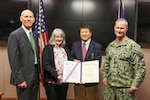 Frank Tse is presented the DON Meritorious Civilian Service Award by NSWC IHD Commanding Officer Capt. Eric Correll (far right) and NSWC IHD Technical Director Ashley Johnson (far left). Also pictured is Frank’s wife Donna Tse.