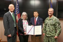 Frank Tse is presented the DON Meritorious Civilian Service Award by NSWC IHD Commanding Officer Capt. Eric Correll (far right) and NSWC IHD Technical Director Ashley Johnson (far left). Also pictured is Frank’s wife Donna Tse.