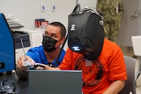 Clifford Ching (left), a welding skills instructor from Pearl Harbor Naval Shipyard and Intermediate Maintenance Facility (PHNSY & IMF) assists a James Campbell High School student using an arc welding simulator during a career-oriented field trip held in mid-April. This event is one of several PHNSY & IMF community outreach programs conducted with local schools. The visit gathered 26 students and three teachers from the school’s Science, Technology, Engineering, Arts, and Mathematics (STEAM) program that offers students insight in trade industry occupations. During the field trip, representatives from the shipyard’s Production Resource Training Department facilitated the students’ experience with a tour of its welding school including welding demonstrations and an overview of equipment and training facilities used in honing welding trade skills. (Official U.S. Navy photo by Justice M. Vannatta)