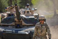 U.S. Army Sgt. 1st Class Layverth Colorado, tank commander and platoon sergeant for 3rd Platoon, Bravo Company, 1st Battalion, 68th Armor Regiment, 3rd Armored Brigade Combat Team, 4th Infantry Division guides an M1A2 Abrams tank into an ammo station as part of Defender 22 at Konotop Range, Drawsko Pomorskie, Poland, May 9, 2022. Defender Europe 22 is a series of U.S. Army Europe and Africa multinational training exercises taking place in Eastern Europe. The exercise demonstrates U.S. Army Europe and Africa’s ability to conduct large scale ground combat operations across multiple theaters in support of NATO. (U.S. Army National Guard  photo by Sgt. Tara Fajardo Arteaga)
