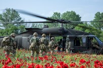 Soldiers assigned to the British 16th Air Assault Brigade Combat Team load a 1st Air Cavalry Brigade UH-60 Blackhawk helicopter in preparation for an air assault training mission during Swift Response, Krivolak Military Training Center, North Macedonia, May 8, 2022. Exercise Swift Response 2022 is an annual multinational training exercise, which takes place in Eastern Europe, the Arctic High North, Baltics, and Balkans from May 2-20, 2022. It aims to present combat credible Army forces in Europe and Africa and enhance readiness by building airborne interoperability with Allies and Partners and the integration of joint service partnerships. (U.S. Army Photo by Sgt. Jason Greaves)