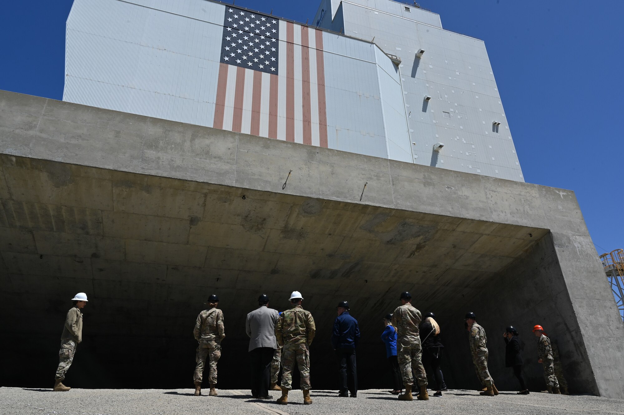 people standing outside a large building