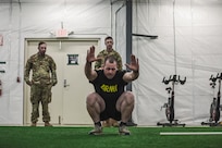 Spc Mark Adair with the 207th Engineer Utilities Detachment performs the Knee Jump during the Best Warrior Competition held at Joint Base Elmendorf-Richardson, Alaska, May 13, 2022. The Knee Jump is one of three Native Youth Olympic sports that Alaska Army National Guardsmen attempted in this year's mystery event for the Best Warrior Competition. (U.S. Army National Guard photo by Pvt. Caleb Lawhorne)