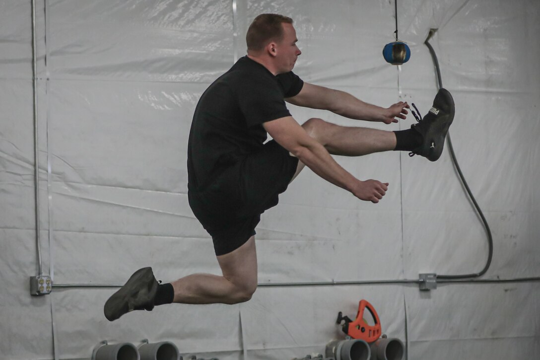 Spc Austin Morton, a military police Soldier assigned to Company A, 49th Missile Defense Battalion attempts the One-Foot High Kick during the mystery event for the Best Warrior Competition held at Joint Base Elmendorf-Richardson, Alaska, May 13, 2022. The mystery event chosen for this year’s competition pays homage to Alaska’s Native American culture by having the Soldiers attempt three sports from the Native Youth Olympics. (U.S. Army National Guard photo by Pvt. Caleb Lawhorne, 134th Public Affairs Detachment).