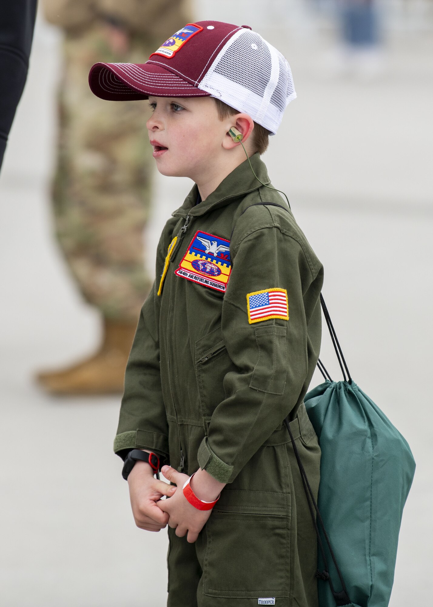 An airshow attendee lines up to watch aerial acts take flight during the Fairchild Skyfest 2022 airshow at Fairchild Air Force Base, Washington, May 15, 2022. Fairchild Skyfest 2022 featured 16 aerial acts and 14 static display aircraft, as well as other attractions and displays. (U.S. Air Force photo by Staff Sgt. Lawrence Sena)