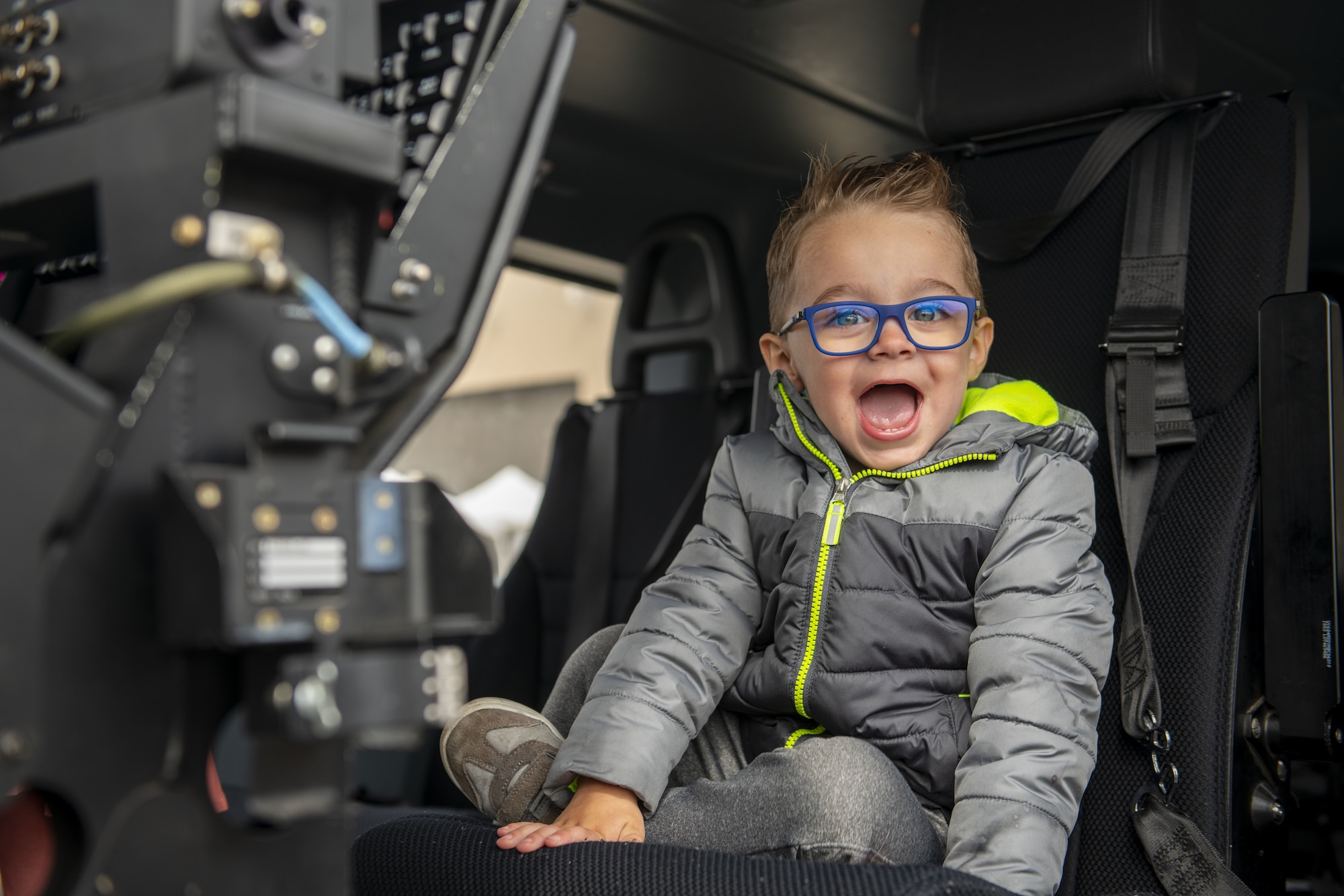 An airshow attendee sits inside a static display during the Fairchild Skyfest 2022 at Fairchild Air Force Base, Washington, May 15, 2022. Team Fairchild held the Fairchild Skyfest 2022 airshow as a means of thanking the local community for their support and partnerships, as well as to inspire future generations of Airmen with a showcase of U.S. Air Force assets and their capabilities. (U.S. Air Force photo by Staff Sgt. Lawrence Sena)
