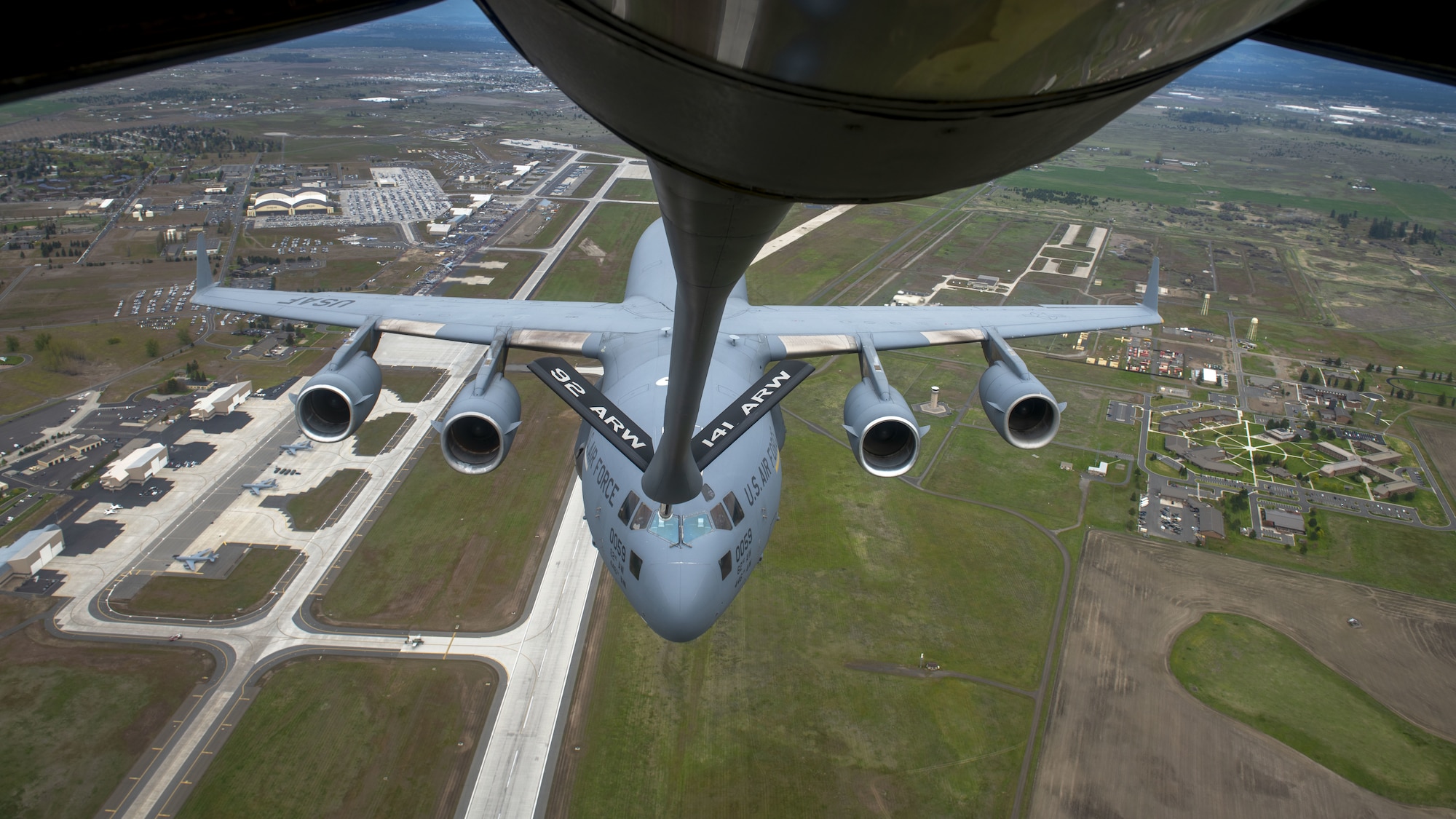 A C-17 Globemaster III and KC-135 Stratonker perform an air refueling demonstration during the Fairchild Skyfest 2022 airshow at Fairchild Air Force Base, Washington, May 15, 2022. Fairchild Skyfest 2022 gave the Inland Northwest a chance to meet members of Team Fairchild and see the U.S. Air Force's premier air refueling wing in action during a simulated KC-135 Stratotanker low-pass refuel of a C-17 Globemaster III. (U.S. Air Force photo by Staff Sgt. Lawrence Sena)
