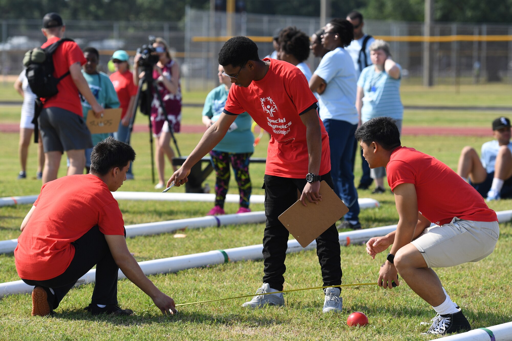 U.S. Air Force Airman 1st Class Diego Vasquez Acosta, Airman Basic Orville Wright, Airman 1st Class James Muyano, 366th Training Squadron students, volunteer during the Special Olympics Mississippi Summer Games at Keesler Air Force Base, Miss., May 14, 2022. Over 600 athletes participated in the Summer Games. (U.S. Air Force photo by Kemberly Groue)