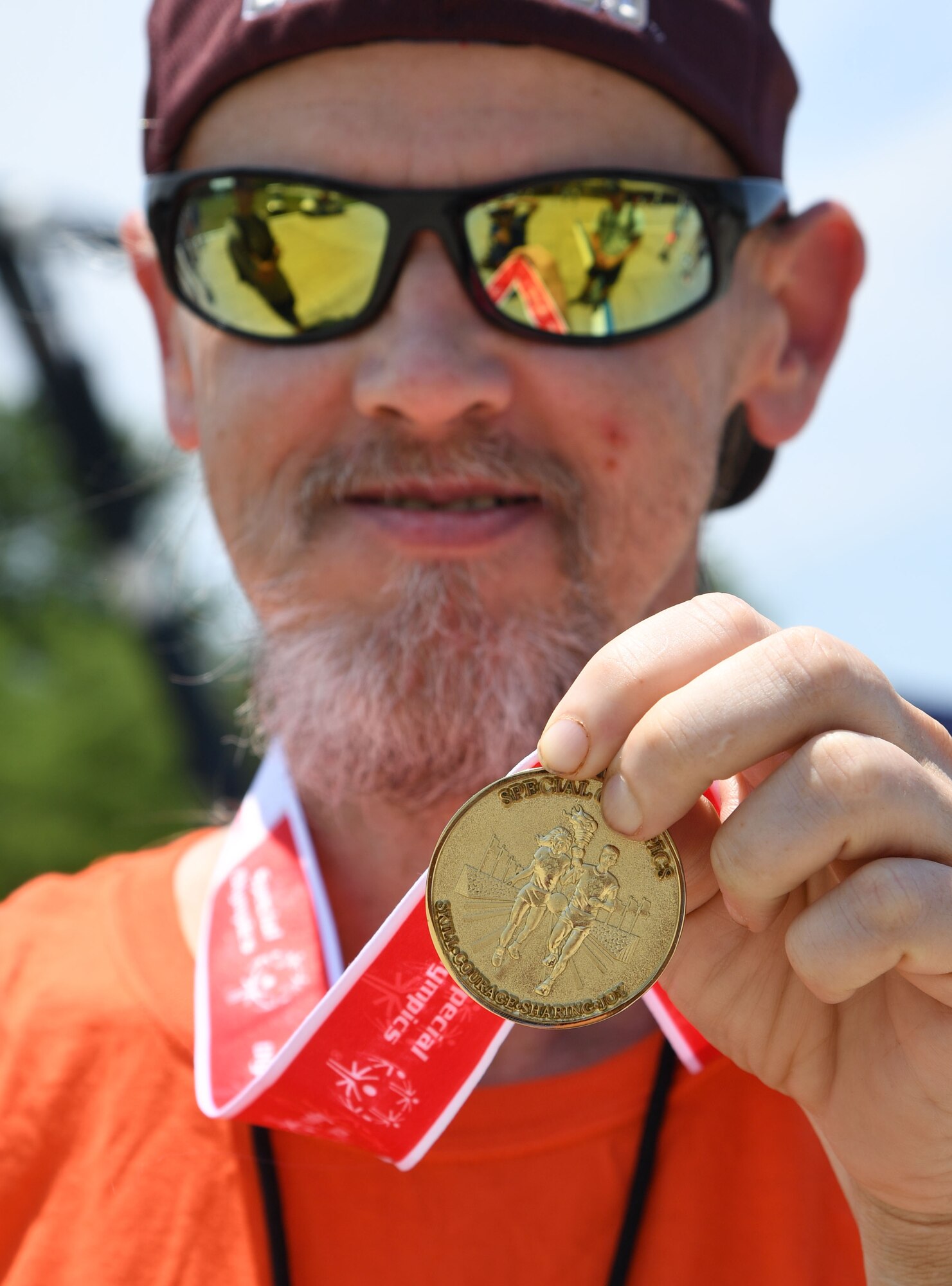 Kevin Boatwright, Area 8 athlete, displays his gold medal during the Special Olympics Mississippi Summer Games at Keesler Air Force Base, Miss., May 14, 2022. Over 600 athletes participated in the Summer Games. (U.S. Air Force photo by Kemberly Groue)
