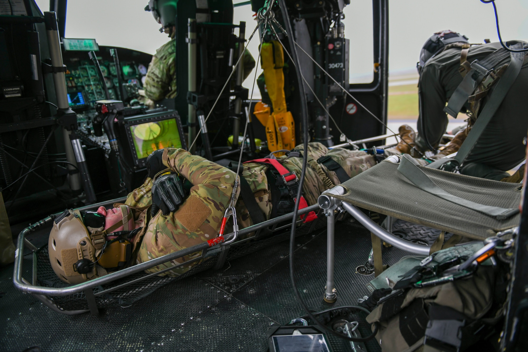 A U.S. Air Force Survival Evasion Resistance Escape Airman is hoisted up into a UH-1 Huey helicopter for a SERE demonstration during Skyfest 2022 at Fairchild Air Force Base, Washington, May 14, 2022. Fairchild Skyfest 2022 offered a unique view of Team Fairchild's role in enabling Rapid Global Mobility for the U.S. Air Force. (U.S. Air Force photo by Airman 1st Class Jenna Bond)