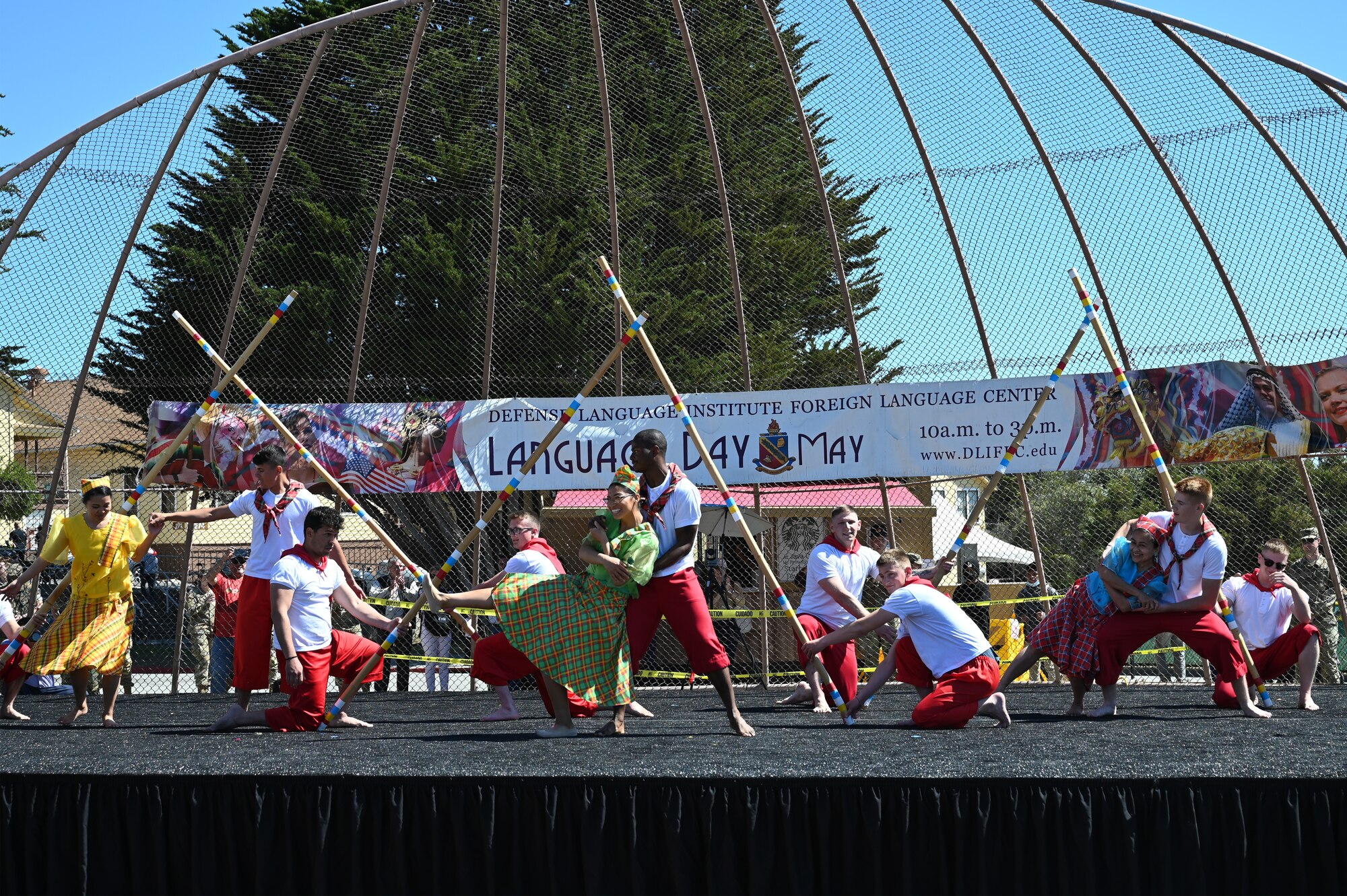 Students and faculty perform a Filipino Tinkling Dance during Language Day, May 13, 2022, at Presidio of Monterey, Calif. More than 45 performances took the stage; each performance was unique to the culture the students were studying and an opportunity to share that culture with their peers. (U.S. Air Force photo by MSgt Jocelyn A. Ford)