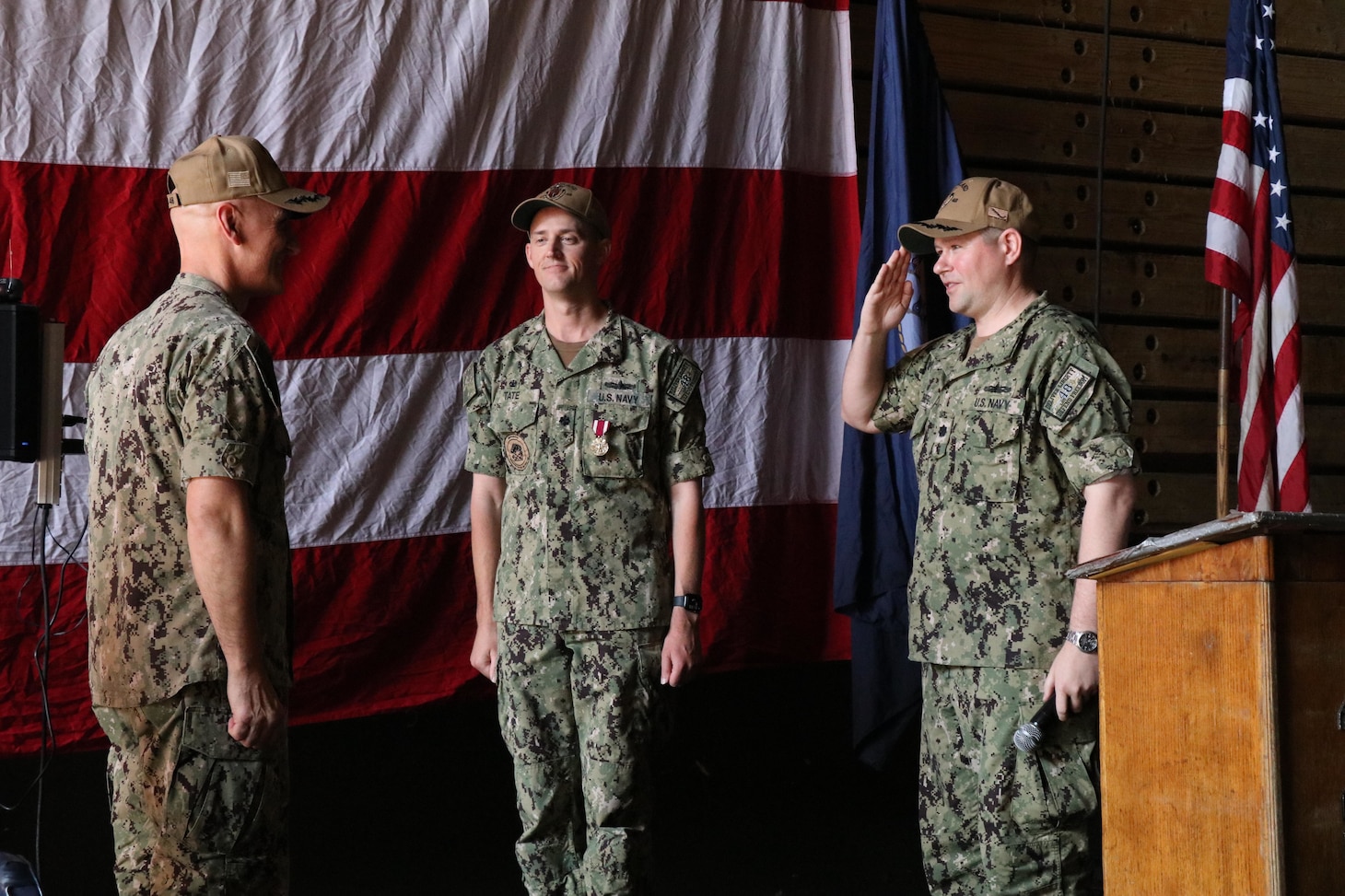 DARWIN, Australia (May 11, 2022) Cmdr. Dirk Sonnenberg, right, 22nd commanding officer of the forward-deployed amphibious dock landing ship USS Ashland (LSD 48), assumes command from Cmdr. Keith Tate, center, during Ashland’s change-of-command ceremony, May 11 in Australia. Ashland, part of Amphibious Squadron 11, is operating in the U.S. 7th Fleet area of responsibility to enhance interoperability with allies and partners, and serve as a ready response force to defend peace and stability in the Indo-Pacific region. (U.S. Navy photo by Lt. j.g. John Malik)