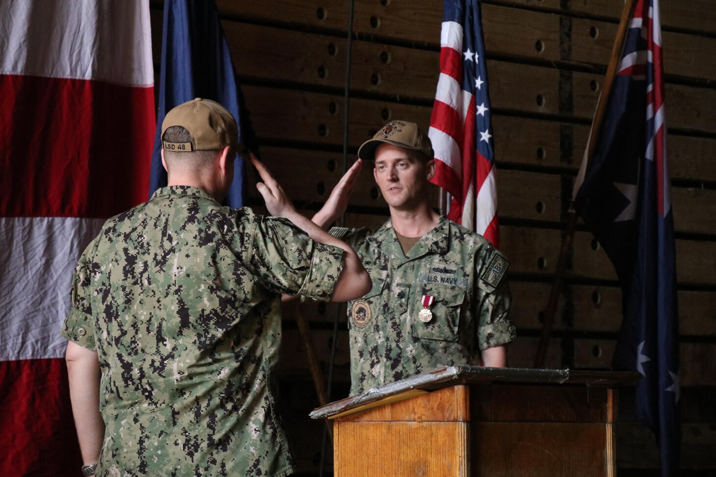 DARWIN, Australia (May 11, 2022) Cmdr. Keith Tate, right, 21st commanding officer of the forward-deployed amphibious dock landing ship USS Ashland (LSD 48), relinquishes command to Cmdr. Dirk Sonnenberg during Ashland’s change-of-command ceremony, May 11 in Australia. Ashland, part of Amphibious Squadron 11, is operating in the U.S. 7th Fleet area of responsibility to enhance interoperability with allies and partners, and serve as a ready response force to defend peace and stability in the Indo-Pacific region. (U.S. Navy photo by Lt. j.g. John Malik)