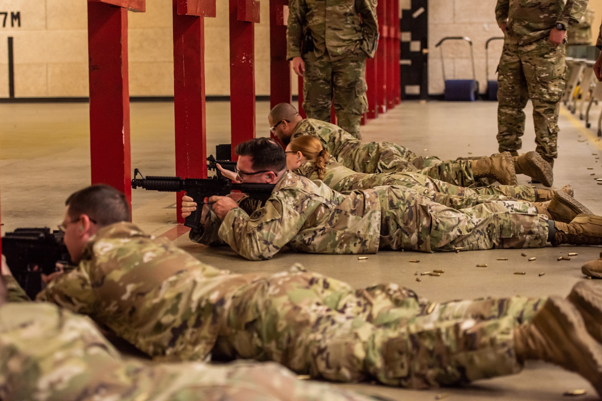 Members of Team Osan fire in the prone position during the M4 portion of the excellence in competition event