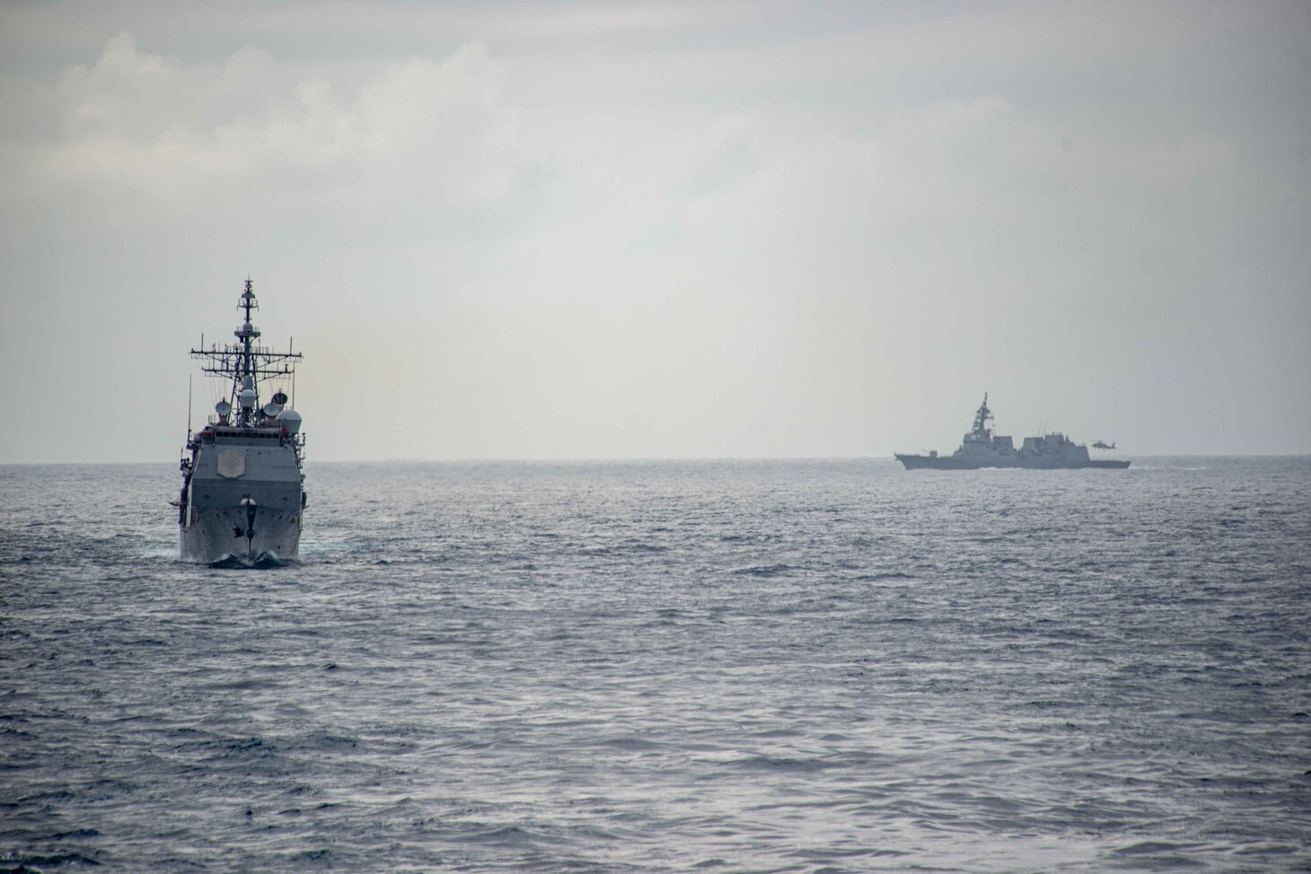 220512-N-DW158-1013 PHILIPPINE SEA (May 12, 2022) Ticonderoga-class guided-missile cruiser USS Antietam (CG 54), left, and Japan Maritime Self-Defense Force (JMSDF) destroyer JS Teruzuki (DD-116) come into formation with the U.S. Navy’s only forward-deployed aircraft carrier USS Ronald Reagan (CVN 76), during a bilateral exercise. The U.S. Navy and JMSDF routinely conduct naval exercises together, strengthening the U.S.-Japan alliance and maintaining a free and open Indo-Pacific region. Ronald Reagan, the flagship of Carrier Strike Group 5, provides a combat-ready force that protects and defends the United States, and supports alliances, partnerships and collective maritime interests in the Indo-Pacific region. (U.S. Navy photo by Mass Communication Specialist 3rd Class Gray Gibson)