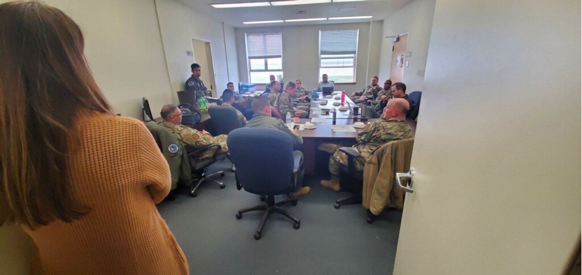 Photo of USAF Airmen participating in a table-top exercise sitting around a table