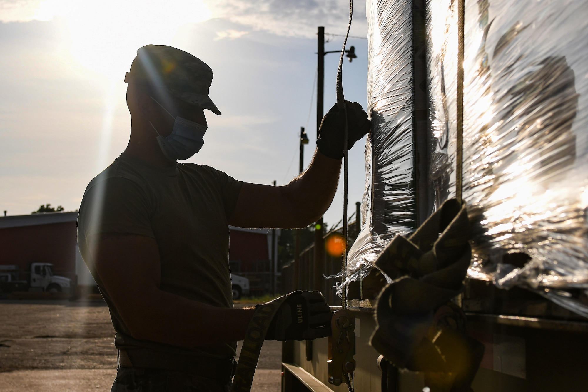 Senior Airman Dustin Osborne, 7th Logistics Readiness Squadron vehicle operator, tightens a strap on cargo Aug. 20, 2021, in Abilene, Texas. The 7th LRS provides distribution and material management to the 7th Bomb Wing and the 317th Airlift Wing at Dyess Air Force Base. (U.S. Air Force photo by Airman 1st Class Josiah Brown)