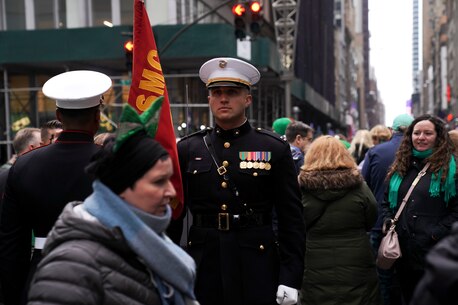 U.S. Marines with the Marine Corps Silent Drill Platoon and the United States Marine Drum & Bugle Corps march to their positions before the start of the New York City St. Patrick's Day Parade in New York, NY, March 17th, 2022. The NYC St. Patrick’s Day parade is held annually along Fifth Avenue to celebrate Irish heritage, commemorate those who died during the Sept. 11, 2001 terrorist attacks, and celebrate first responders and essential workers. (U.S. Marine Corps photo by Sgt. Tojyea G. Matally)