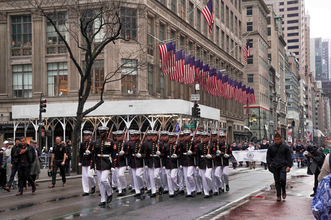 U.S. Marines with the Marine Corps Silent Drill Platoon march during the New York City St. Patrick's Day Parade in New York, Mar. 17, 2022. The NYC St. Patrick’s Day Parade is held annually along Fifth Avenue to celebrate Irish heritage, commemorate those who died during the Sept. 11, 2001 terrorist attacks, and celebrate first responders and essential workers. (U.S. Marine Corps photo by Sgt. Tojyea G. Matally)