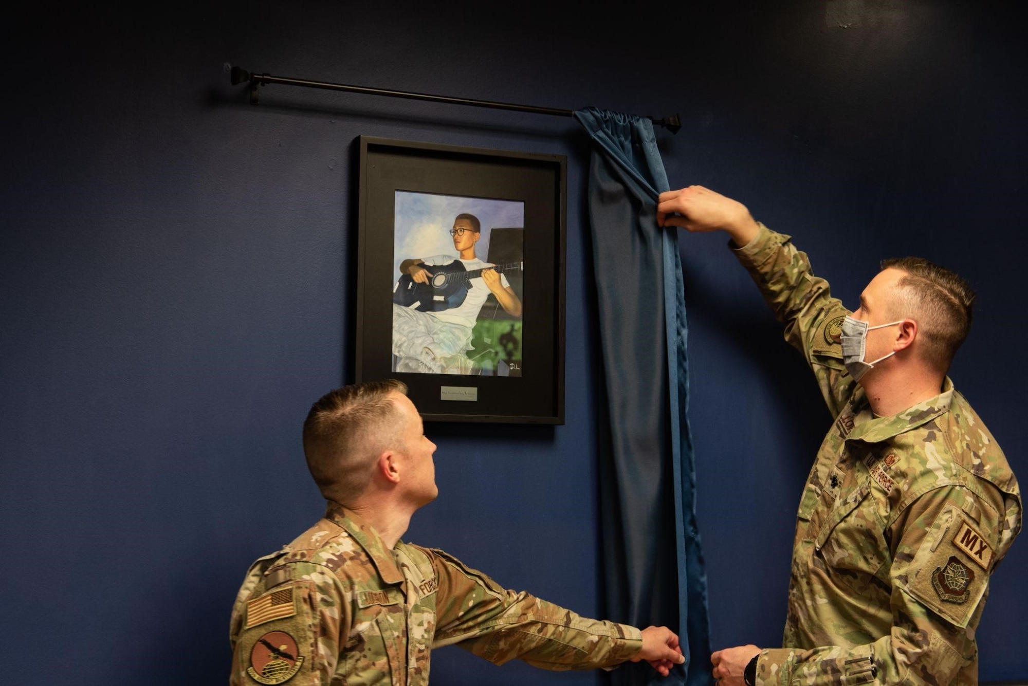 U.S. Air Force Lt. Col. Benjamin Lowry and Staff Sgt. Joshua Logsdon unveil a plaque dedicated to Staff Sgt. Franklin Kaunang